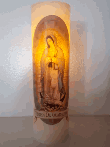 a candle with a picture of the virgin of guadalupe