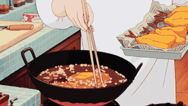 a person is dipping chopsticks into a pan of food