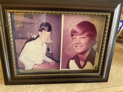 a framed picture of a man with red hair and a woman smiling