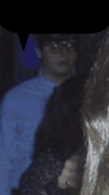 a blurry picture of a man in a blue shirt