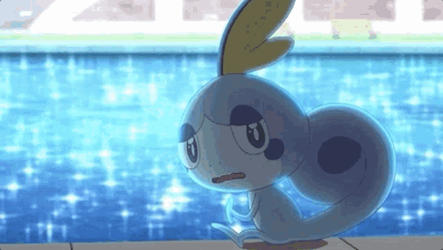 a pokemon is sitting on the edge of a swimming pool .