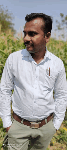 a man wearing a white shirt with a pen in his pocket