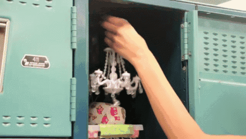 a person reaches into a locker with a sticker that says 49
