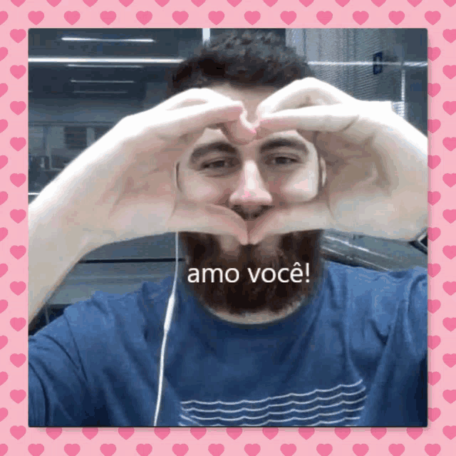 a man with a beard is making a heart shape with his hands and the words amo você written below him