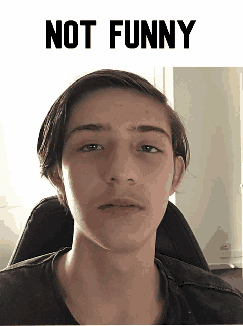 a picture of a young man with the words " not funny " behind him