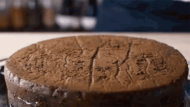 a close up of a chocolate cake with a crack in the middle