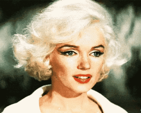 a close up of a woman 's face with blonde hair and red lipstick