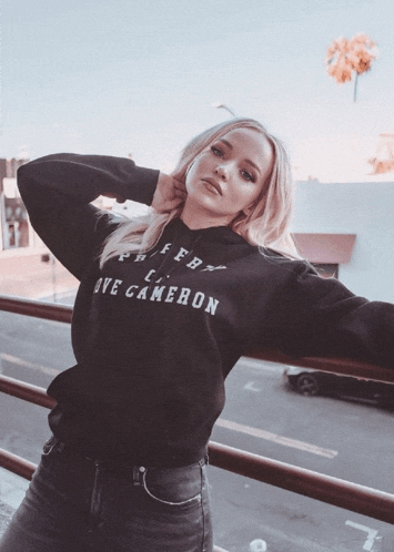 a woman wearing a black hoodie that says love cameron on it