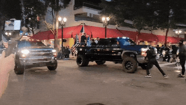 a gmc truck is parked in front of a building