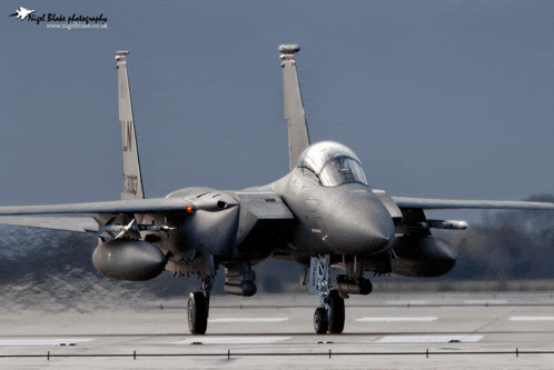 a fighter jet is on a runway and is being photographed by nigel blake