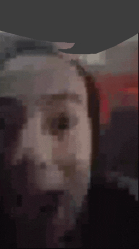 a blurred image of a person 's face with a gray background