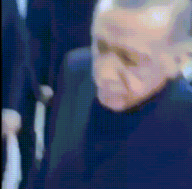 a blurry picture of a man 's face in a dark room .