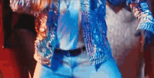 a close up of a person wearing a blue jacket and blue jeans .