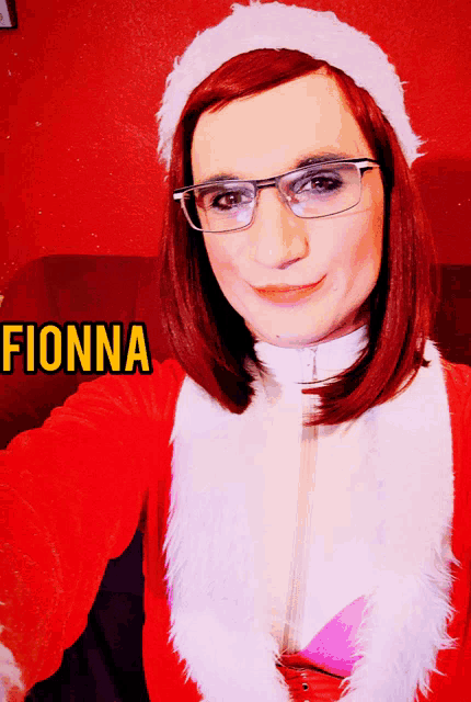 a woman with red hair and glasses is wearing a santa outfit and the name fionna is on the bottom