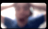 a blurry picture of a person 's face with their hands on their head