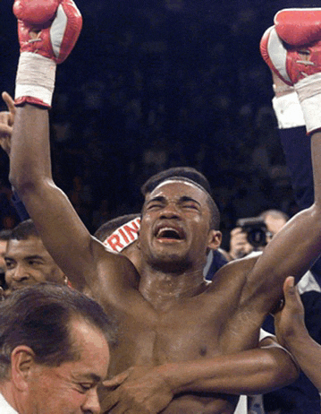 a man wearing boxing gloves has the word ring on his wrist