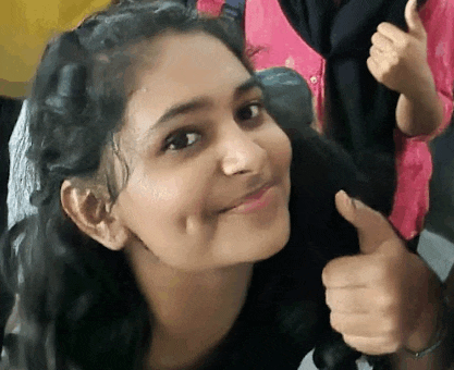 a young woman is giving a thumbs up sign