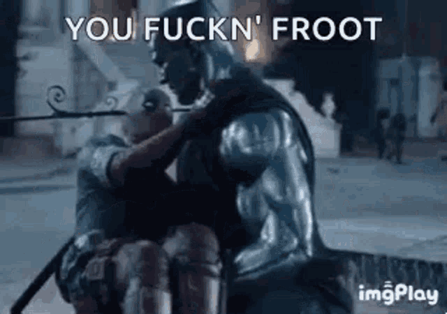 a man in armor is holding another man in a wheelchair in a video game .