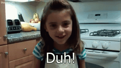 a little girl is sitting in front of a stove with the words duh on her face