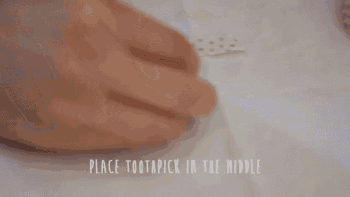 a person is placing a toothpick in the middle