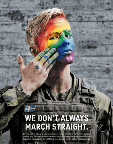 a man with rainbow paint on his face says we don t always march straight