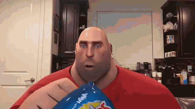 a bald man in a red shirt is holding a bag of m & m 's