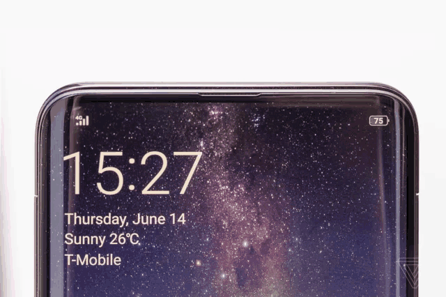 a cell phone displays the time as 15:27