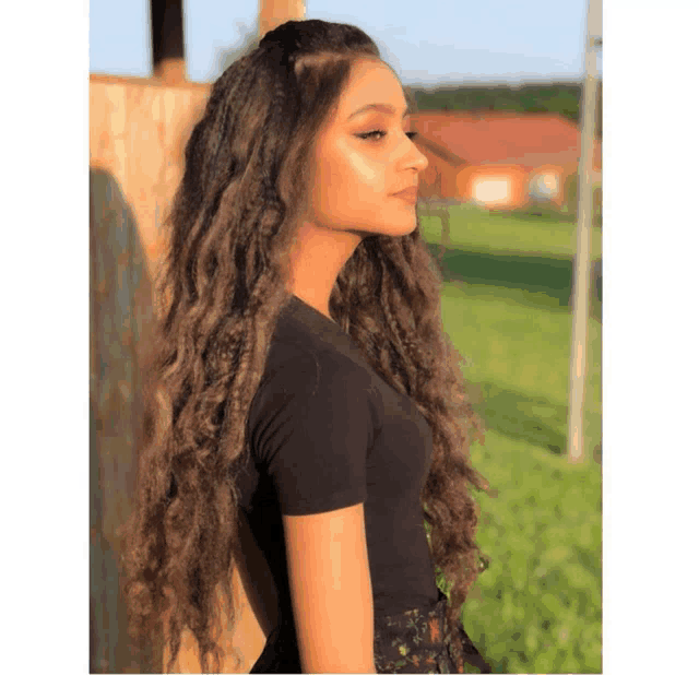 a woman with long hair wearing a black shirt