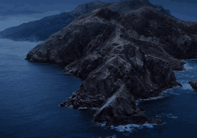 a large rocky cliff overlooking a body of water