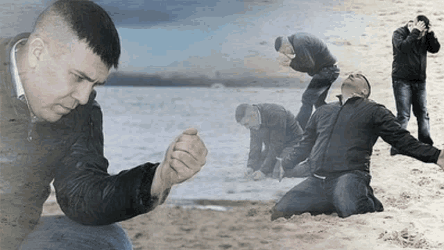 a man in a black jacket kneeling on the beach