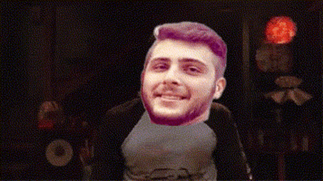 a man with purple hair is smiling in front of a sign that says burn .