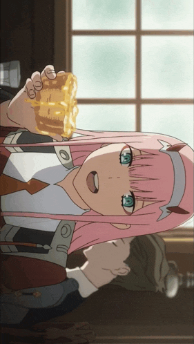 a girl with pink hair and blue eyes is holding a piece of cake in her hand