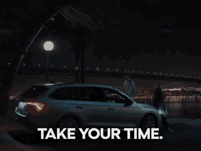 a woman standing next to a car with the words take your time