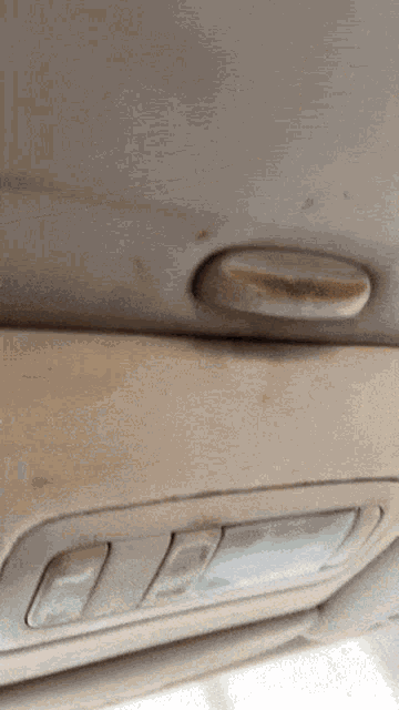 a close up of a car ceiling with a light on
