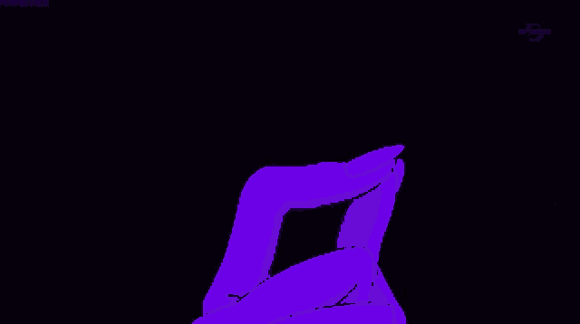 a person is holding a purple lightning bolt in their hands in the dark .