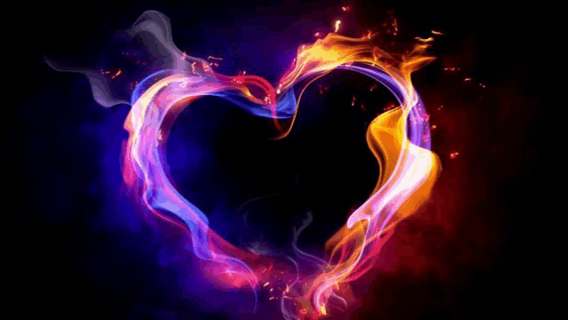 a colorful heart made of fire and smoke on a black background