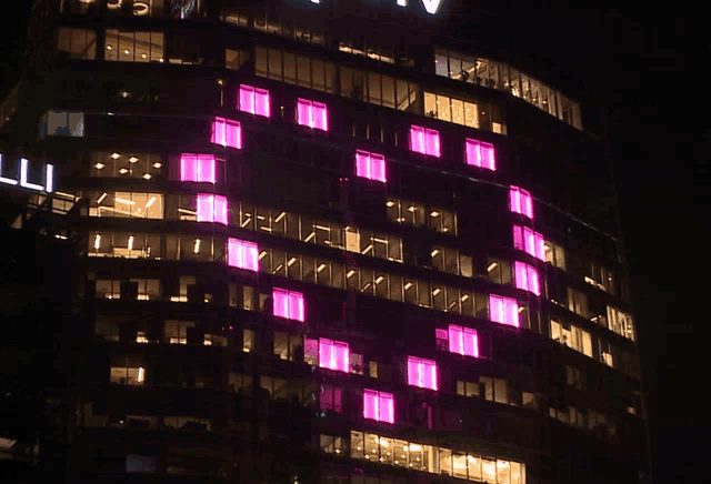 a building with a lot of windows lit up at night with the letters ll on it