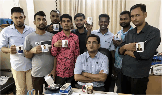 a group of men are posing for a photo while holding mugs with pictures of themselves on them