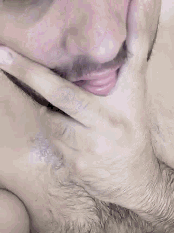 a close up of a man 's mouth with his hand on it