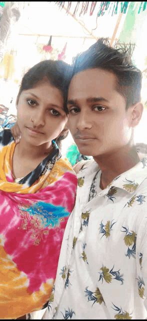 a man and woman are posing for a picture together