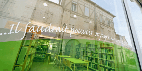 a library with the words il faudrait pouvoir voyager visible