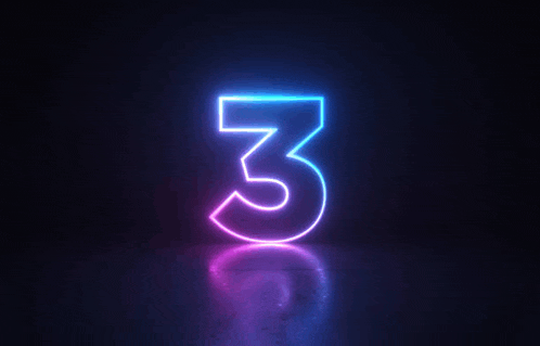 the number three is glowing in the dark and has a reflection on the floor .