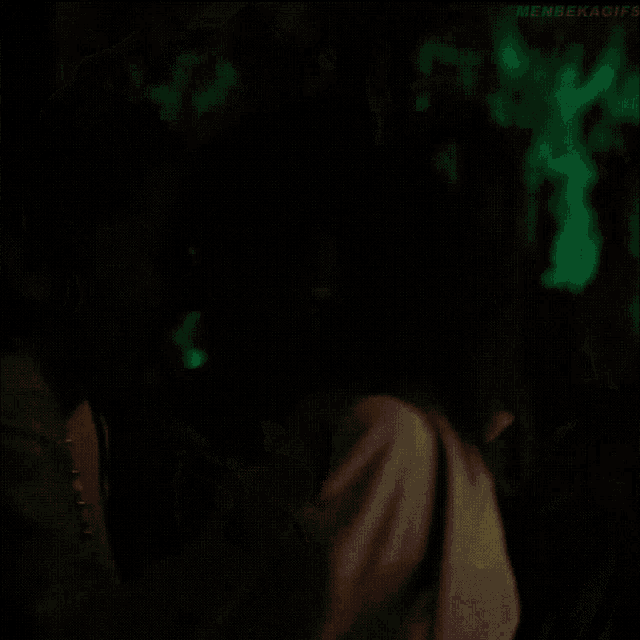 a woman 's back is shown in a dark room with the words men 's health visible on the bottom