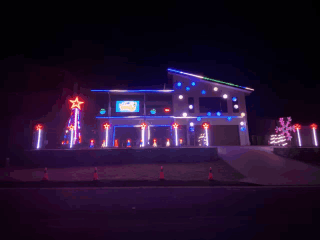 a house decorated with christmas lights and a sign that says ' a christmas family '