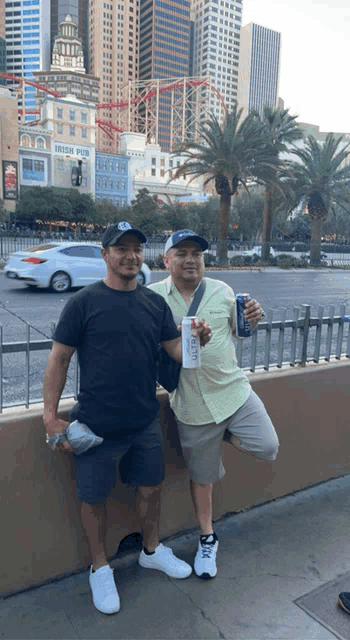 two men standing in front of a building that says irish pub on it