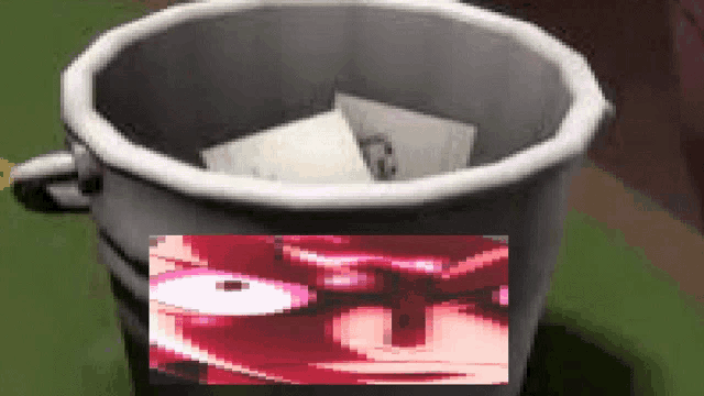 a trash can with papers in it and a picture of a person 's face on it