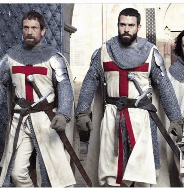 a group of men in armor with a cross on their shirts