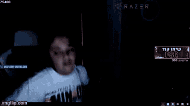 a screenshot of a person screaming in front of a razer banner
