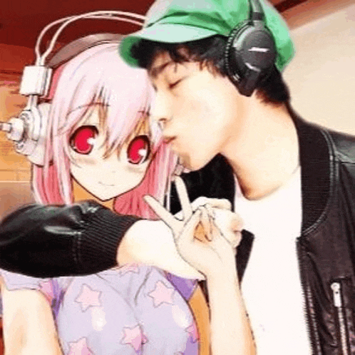 a man wearing headphones is kissing a girl wearing headphones .