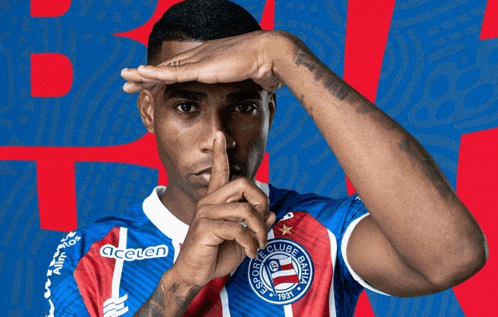 a man wearing a colorful shirt that says esporte clube bahia